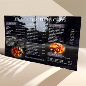 Black Halibut King Fish & Chips menu board with white text and food photographs.